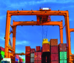 Industrial-spreader-crane-or-quay-crane-discharging-a-cargo-cont
